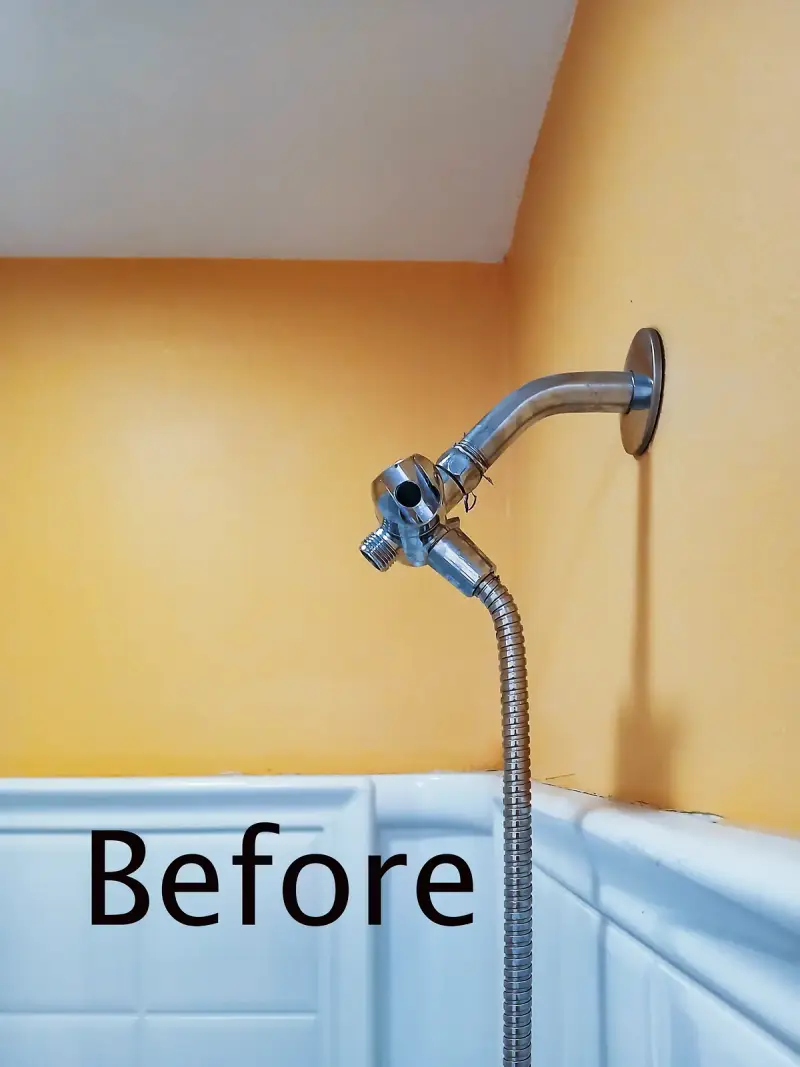Old single shower head before replacement