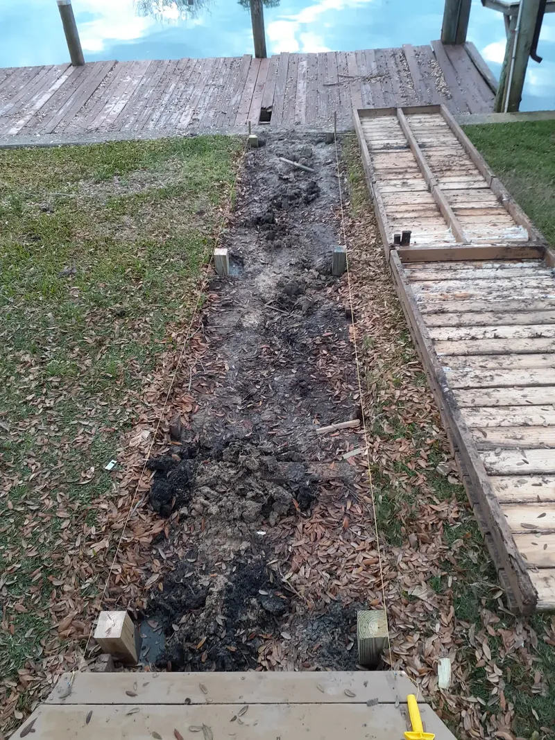 Old walkway removed and string lines set for the new one
